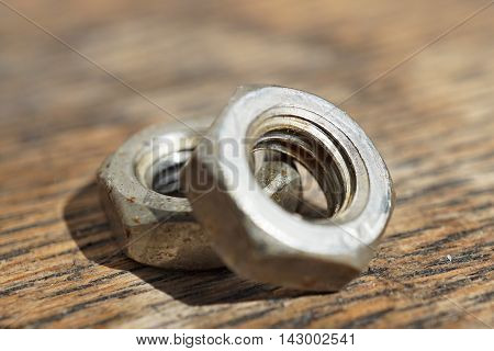Macro detail of a siver metal small nut (Replacement nut)