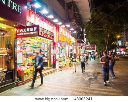 HONG KONG CHINA - OCT 22: Crowded street view at night on October 22 2015 in Hong Kong China. With 7M population and land mass of 1104 sq km it is one of the most dense areas in the world.