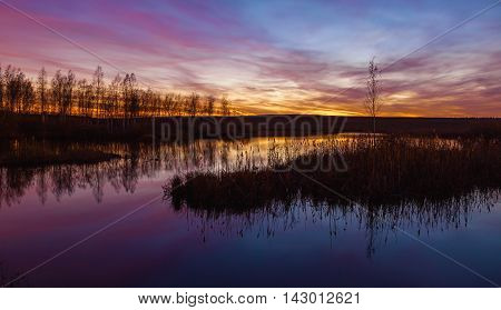 Dramatic sunset with reflectiion on the lake