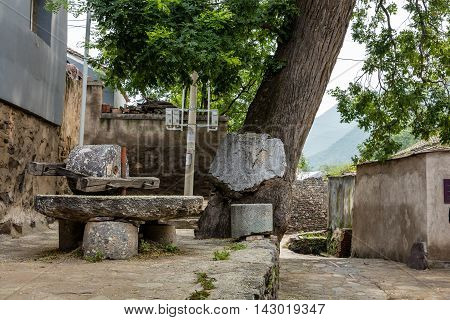 millstone in the corner of an old village