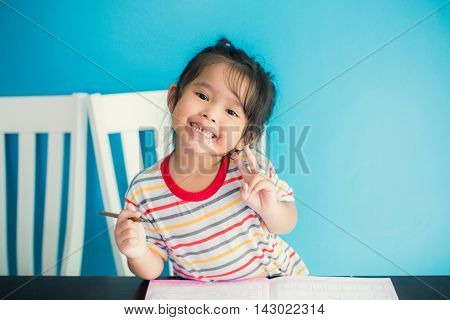 asian young girl children happy doing her homework people, family concept