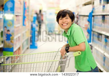 beautiful asian woman so happy shopping in a supermarket