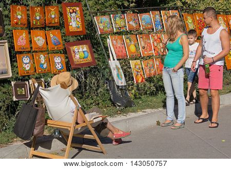 Kiev Ukraine - September 20 2015: Passers-by examine the work of the artist sold the painting in the street Andrew's Descent