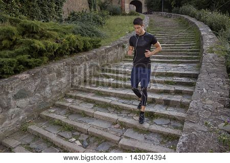 Young man athlete jogger runner stairs athlete