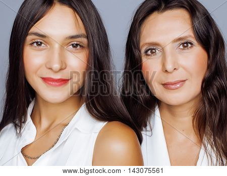 cute pretty teen daughter with mature mother hugging, fashion style brunette makeup close up, real happy family