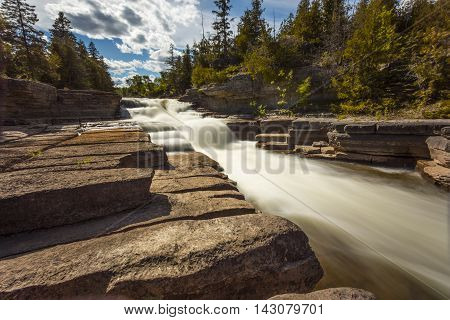 Daytime view of Fouth Chute cascade in Eganville Ontario Canada during a sunny day