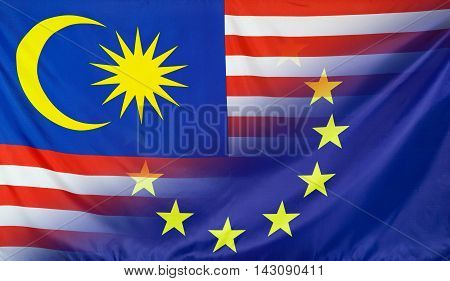 Malaysia and European Union relations concept with diagonally merged real fabric flags