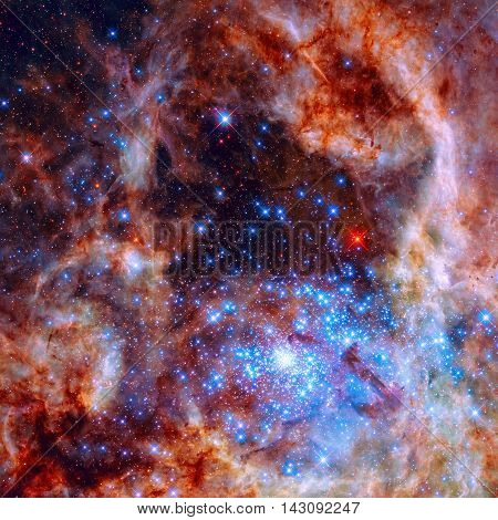 Central region of the Tarantula Nebula in the Large Magellanic Cloud. The young and dense star cluster R136. Retouched colored image. Elements of this image furnished by NASA.