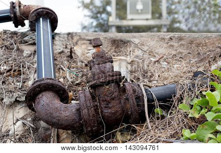 Old rusty industrial water pipe on rodeside