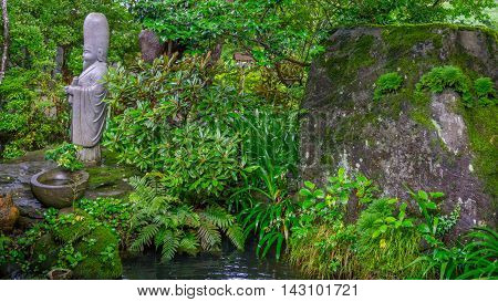 Small statue found in the quietness of a Japanese garden
