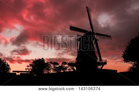 De Molen windmill of Foxton New Zealand with a red cloud sunset.
