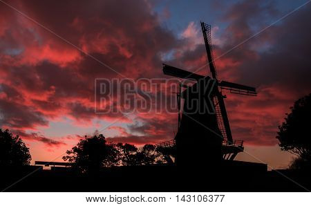 De Molen windmill of Foxton New Zealand with a red cloud sunset.