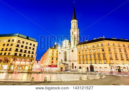 Vienna Austria. Michaelerplatz wide-angle view at dusk with Michaelkirche Habsburg Empire landmark in Wien