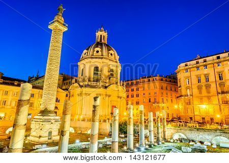Rome Italy. The church Most Holy Name of Mary and the Roman Triumphal Column at twilight on Trajan Forum.