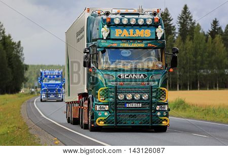 URJALA, FINLAND - AUGUST 11, 2016: Green Scania V8 of K.E.Palms Akeri moves along highway in truck convoy on the way to the annual trucking event Power Truck Show 2016 in Alaharma Finland.