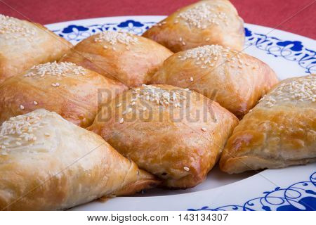 Fresh baked samosas on a big dish
