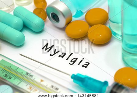 Myalgia - diagnosis written on a white piece of paper. Syringe and vaccine with drugs.