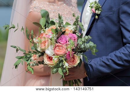 Bride Holding A Beautiful Bridal Bouquet. Wedding Bouquet Of Peach Roses By David Austin,  Single-he