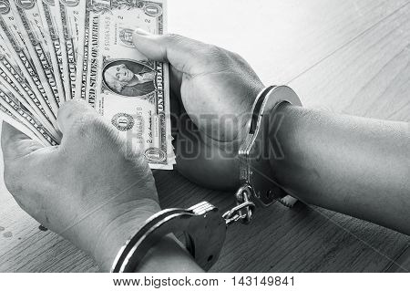 Hand young man in handcuffed hold money black and white tone