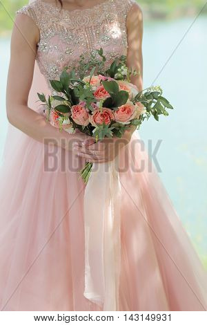 Beautiful Bridal Bouquet In Hands Of The Bride. Wedding Bouquet Of Peach Roses By David Austin,  Sin