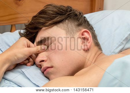 Teenage boy fast alseep in his bed