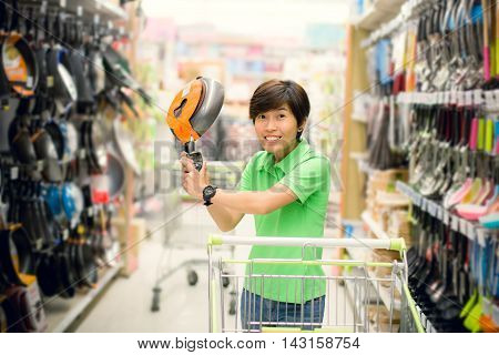 Beautiful asian woman so happy shopping in a supermarket