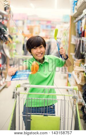 Beautiful asian woman so happy shopping in a supermarket