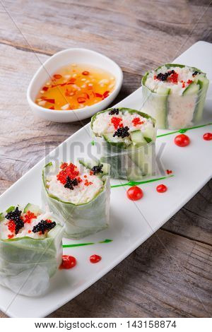 Spring roll with caviar cucumber and cili sauce