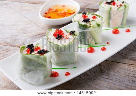 Spring roll with caviar cucumber and cili sauce