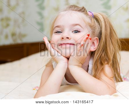 Little Girl Lying On The Bed