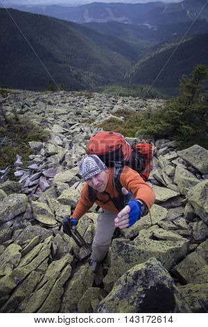 Mountain instructor handed someone a helping hand to the top of the mountain.