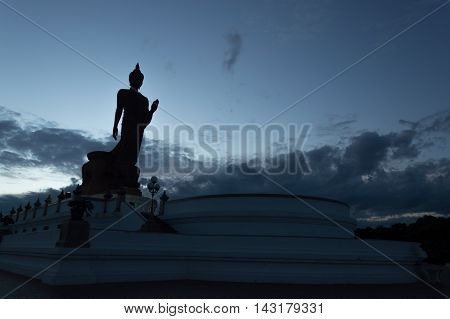 Walking Buddha statue at Buddhamonthon (Phutthamonthon) Buddhist Park in Nakhon Pathom Thailand in twilight moment