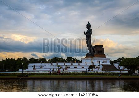 Sunset Over Walking Buddha Statue At Buddhamonthon (phutthamonthon), Buddhist Park In Nakhon Pathom,