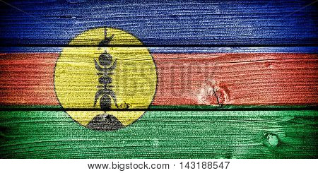Flag of New Caledonia painted on old grungy wooden background: 3d illustration
