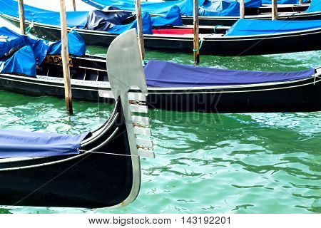 Ferro of gondola docked on the venetian lagoon closeup