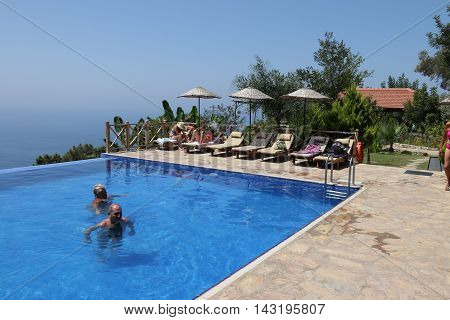 29TH JULY 2016, KABAK, TURKEY : English tourists having a swim and cooling off in an infinity pool at Kabak in Turkey, 29th july 2016