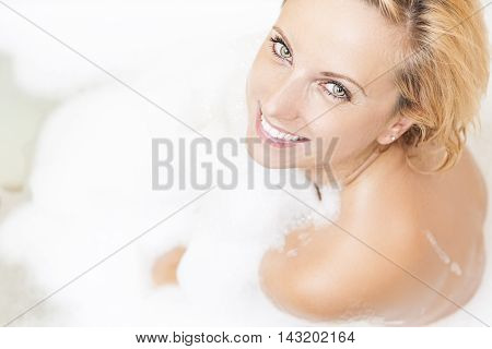 Portrait of Caucasian Relaxing Woman in Bath Shower. Much Foam Used.Horizontal Image Composition
