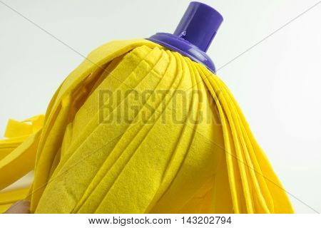 Yellow mop on white background. cleaner floor