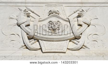Neoclassical decoration with winged deity and two monsters face each other from Vittoriano monument in Rome designed by Sacconi in 1883