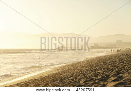 Santa Monica California sunset on Pier Ferris wheel and reflection on beach wet sand