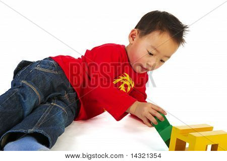 Chinese Boy Playing With Toys