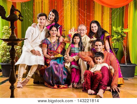 group photo of happy indian family in ganesh festival, happy indian family celebrating ganpati festival or ganesh utsav or ganesh festival
