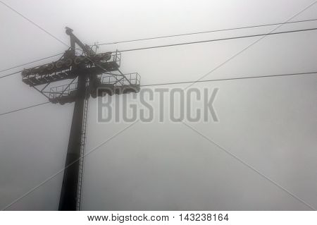 cable way in deep mist on white background