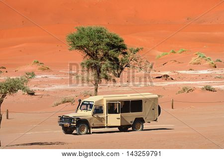 SOSSUSVLEI NAMIBIA - JAN 29 2016: Safari car in the Namib-Naukluft National Park. The most visited place in Namibia