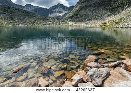 Stones in the water and reflection of Musalenski lakes,  Rila mountain, Bulgaria
