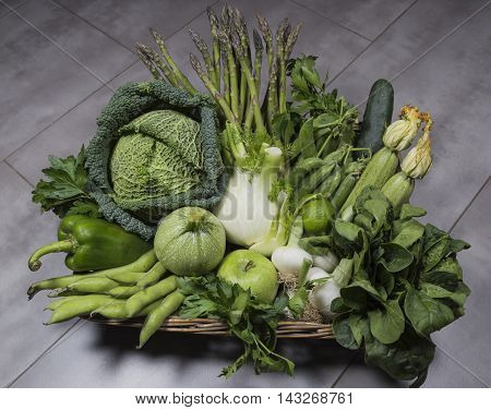 Green vegetables in wicker basket in spring