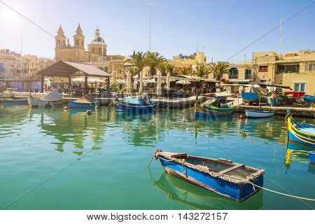 Malta - Marsaxlokk market with traditional colorful Luzzu fishing boats