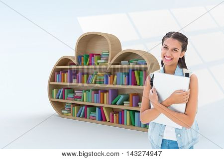 Student holding laptop against digital image of pattern