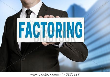 factoring sign is held by businessman background
