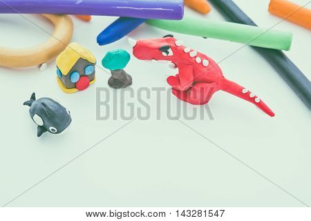 Beautiful play dough animal. Creative clay animal model. Top view of red dinosaur whale house and tree from children bright play dough. Studio shot. Vintage tone effect.